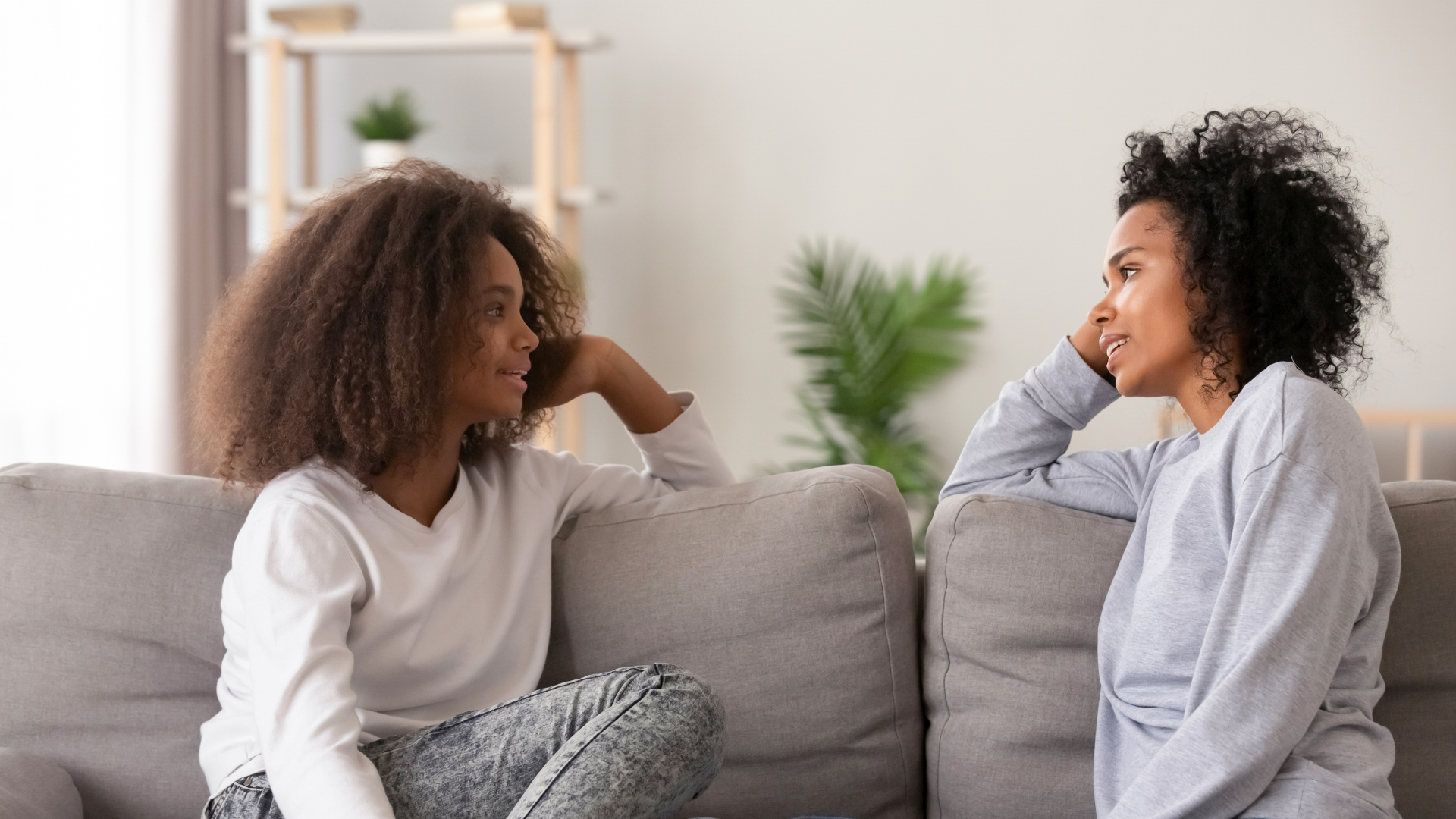 Parent and child having a meaningful conversation about screen time on the couch